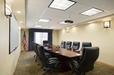 a conference room with a long table and chairs at Holiday Inn & Suites - Barstow by IHG in Barstow