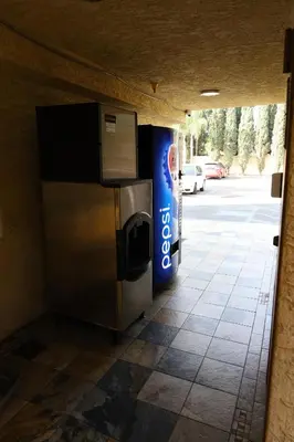 a vending machine with a drink dispenser next to a street at Lambert Inn in Whittier
