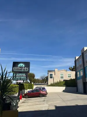 a car parked in a parking lot with a sign at Vista Motel in Los Angeles