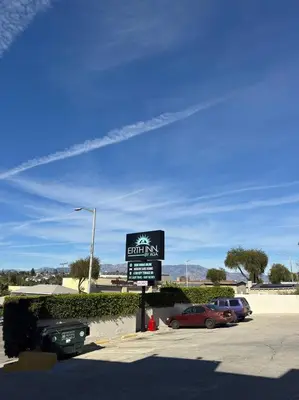 a sign for a parking lot with cars parked at Vista Motel in Los Angeles