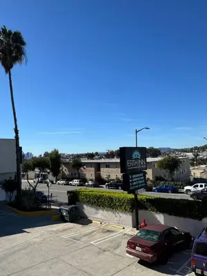 a parking lot with a sign for a car dealership at Vista Motel in Los Angeles