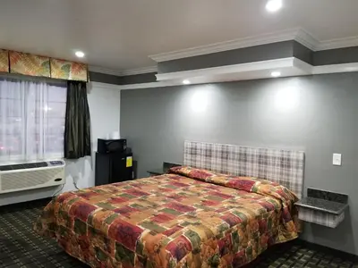 a hotel room with a bed and a window at Rodeway Inn Commerce - Los Angeles in Commerce