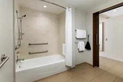 a bathroom with a white tub and a shower at The Anza-a Calabasas Hotel in Calabasas