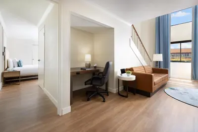 a hotel room with a desk and a bed at The Anza-a Calabasas Hotel in Calabasas