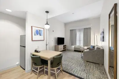 a living room with a table and a couch at Homewood Suites Lancaster in Lancaster