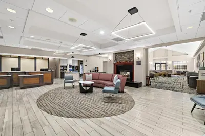 a lobby of a hospital with a couch and chairs at Homewood Suites Lancaster in Lancaster