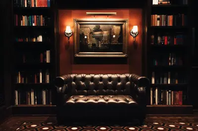 a leather couch in a library with books at Los Angeles Athletic Club in Los Angeles
