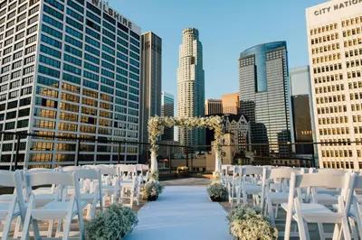 a row of white chairs in front of a city at Los Angeles Athletic Club in Los Angeles