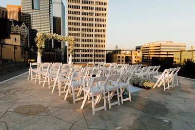 a row of white chairs sitting on top of a building at Los Angeles Athletic Club in Los Angeles