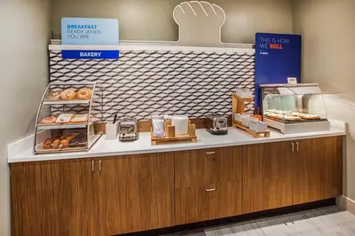 a bakery with a counter with donuts on it at Holiday Inn Express Porterville by IHG in Porterville