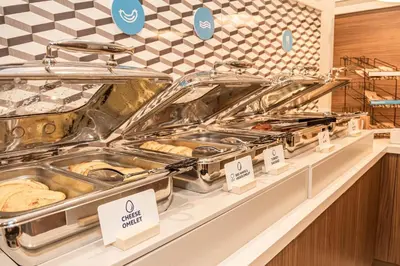 a buffet line with trays of food in a store at Holiday Inn Express Porterville by IHG in Porterville