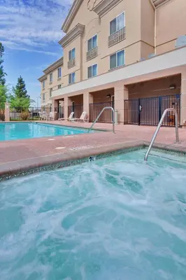 a swimming pool in front of a building at Holiday Inn Express Porterville by IHG in Porterville