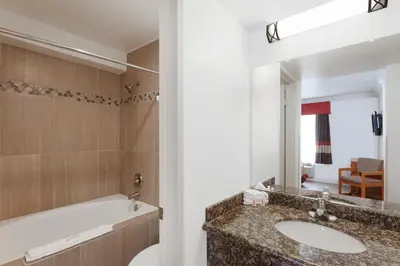 a bathroom with a sink and a mirror at Super 8 by Wyndham Santa Clarita/Valencia in Santa Clarita