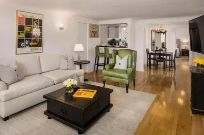 a living room with a couch and a table at The Charlie West Hollywood in Los Angeles
