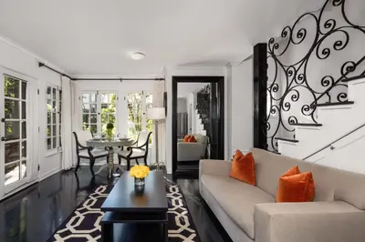 a living room with a couch and a table at The Charlie West Hollywood in Los Angeles