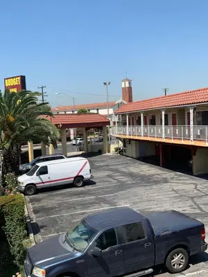 a car parked in a parking lot in front of a motel at Budget Inn Motel in San Gabriel