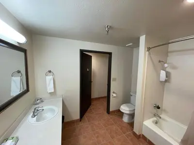 a bathroom with a sink and a toilet and a mirror at Oakridge Inn in Oak View