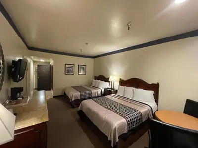 a hotel room with two beds and a tv at Oakridge Inn in Oak View