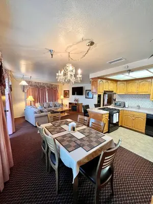 a kitchen and living room with a table and a couch at Oakridge Inn in Oak View