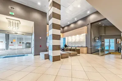a lobby of a building with a staircase and a lobby at Hotel Huntington Beach in Huntington Beach
