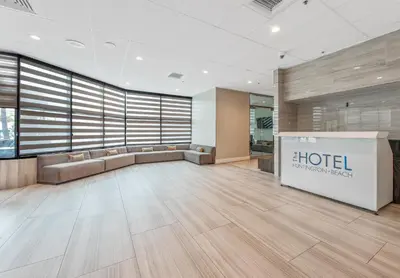 an office lobby with a hotel sign on the wall at Hotel Huntington Beach in Huntington Beach