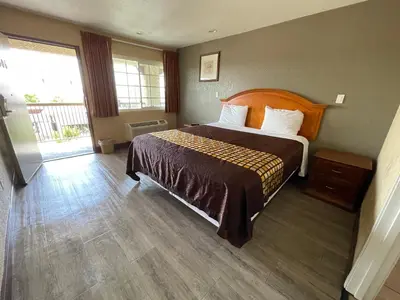 a bedroom with a bed and a large window at Arlington Inn in Riverside