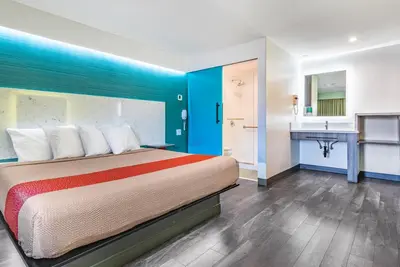 a hotel room with a bed and a sink at Solo Motel Broadway in Los Angeles