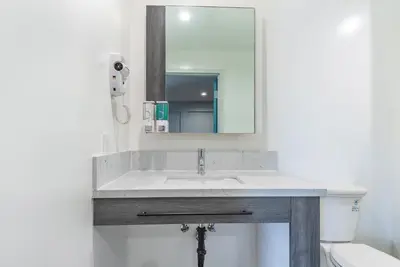a bathroom with a sink and a mirror at Solo Motel Broadway in Los Angeles