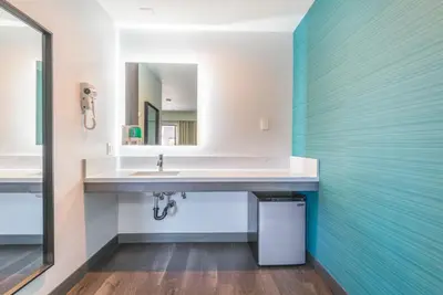 a bathroom with a sink and a mirror at Solo Motel Broadway in Los Angeles
