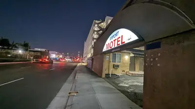 a mobil gas station on a city street at night at Airport Motel - Inglewood in Inglewood