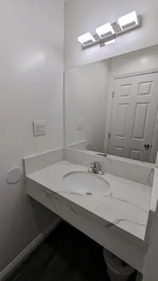 a white bathroom with a sink and a mirror at Airport Motel - Inglewood in Inglewood