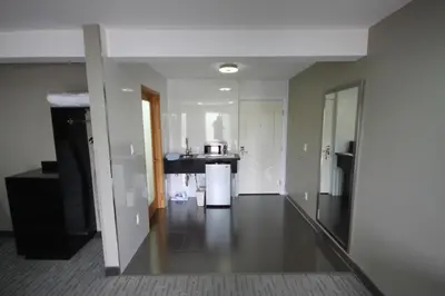 an empty room with a kitchen and a living room at Grandview Inn in Hermosa Beach