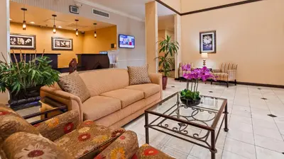 a living room with a couch and a table at Best Western Route 66 Glendora Inn in Glendora