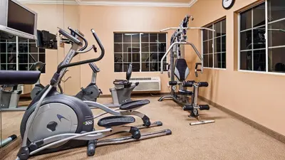 a gym with three exercise bikes in a room at Best Western Route 66 Glendora Inn in Glendora