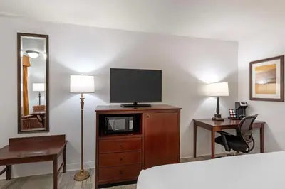 a hotel room with a bed and a television on a dresser at Best Western Plus Redondo Beach Inn in Redondo Beach