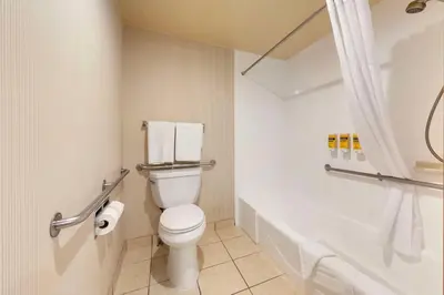 a bathroom with a toilet and a bath tub at Best Western Plus Redondo Beach Inn in Redondo Beach