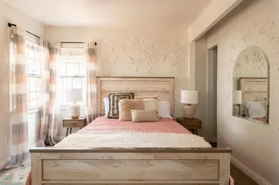 a bedroom with a large bed with a wooden headboard at Lakewood Cabins in Big Bear Lake