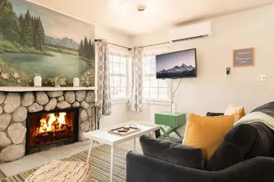 a living room with a fireplace and a tv at Lakewood Cabins in Big Bear Lake