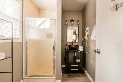 a bathroom with a shower with a glass door at Lakewood Cabins in Big Bear Lake