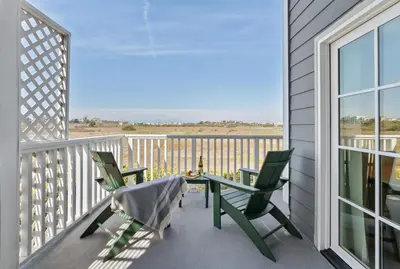 a patio with two chairs and a table on a balcony at Inn at Playa del Rey in Los Angeles