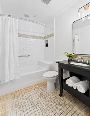 a bathroom with a tub and a toilet and a sink at Inn at Playa del Rey in Los Angeles