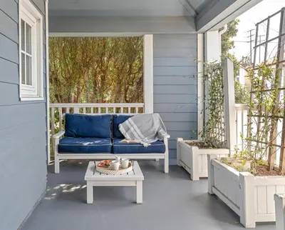 a blue couch on the porch of a house at Inn at Playa del Rey in Los Angeles