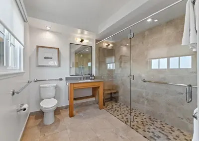 a bathroom with a shower and a toilet and a sink at Inn at Playa del Rey in Los Angeles
