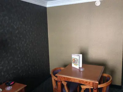 a table and two chairs in a room at Crystal Inn Suites & Spas in Inglewood
