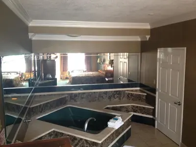 a kitchen with a sink and a living room at Crystal Inn Suites & Spas in Inglewood