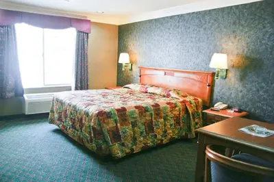 a hotel room with a bed and a desk at Crystal Inn Suites & Spas in Inglewood