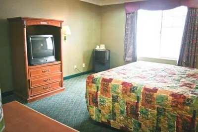 a hotel room with a bed and a tv at Crystal Inn Suites & Spas in Inglewood