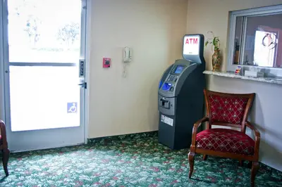 a ticket office with a chair next to a door at Crystal Inn Suites & Spas in Inglewood