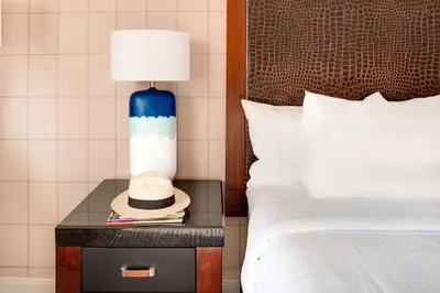 a hat on a table next to a bed at Hotel Lulu, BW Premier Collection in Anaheim