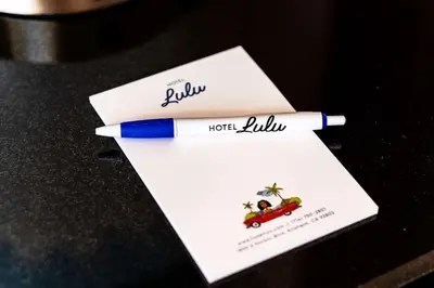 a blue pen sitting on top of a white envelope at Hotel Lulu, BW Premier Collection in Anaheim